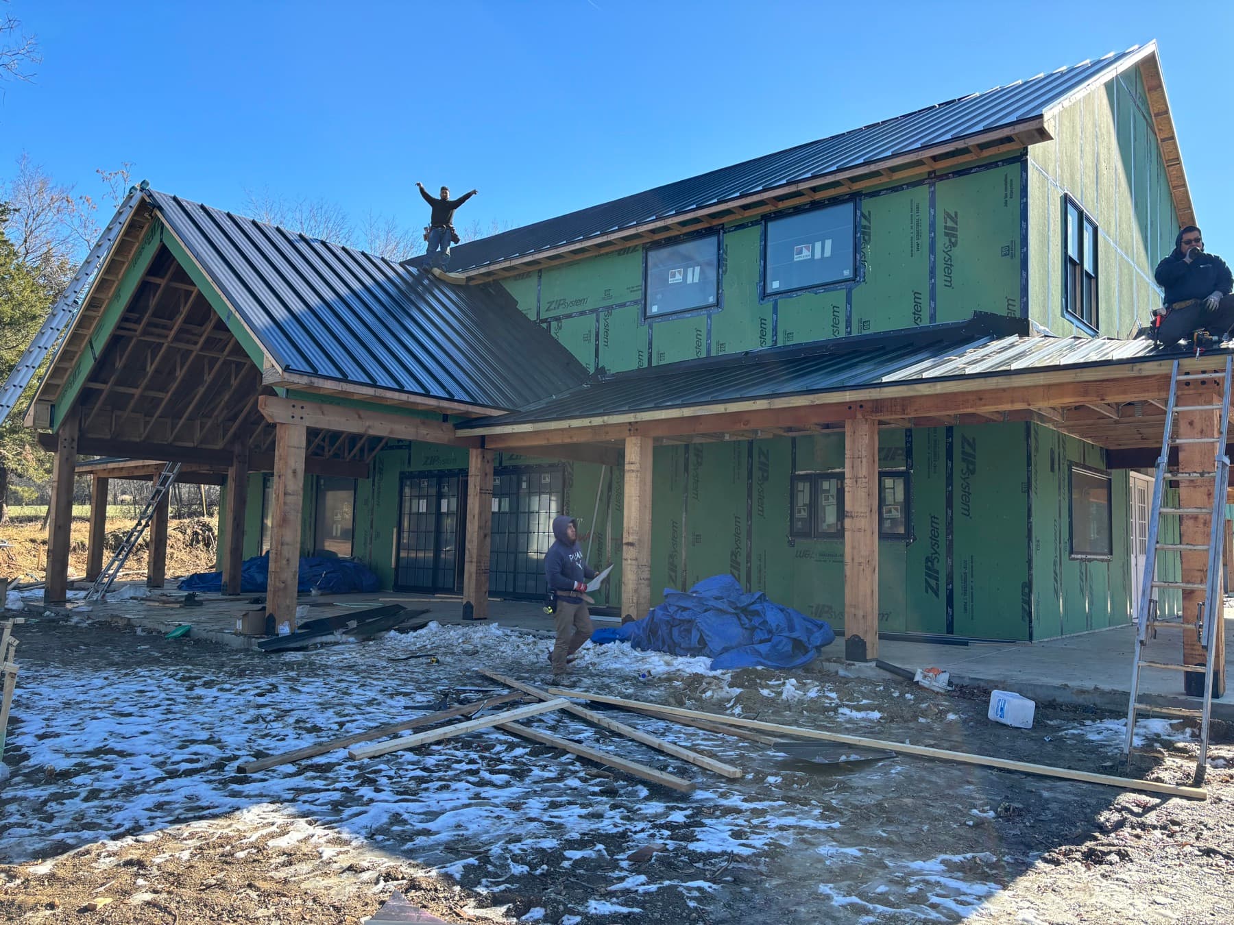 Barnhouse Structures crew framing and roofing a barndominium in progress